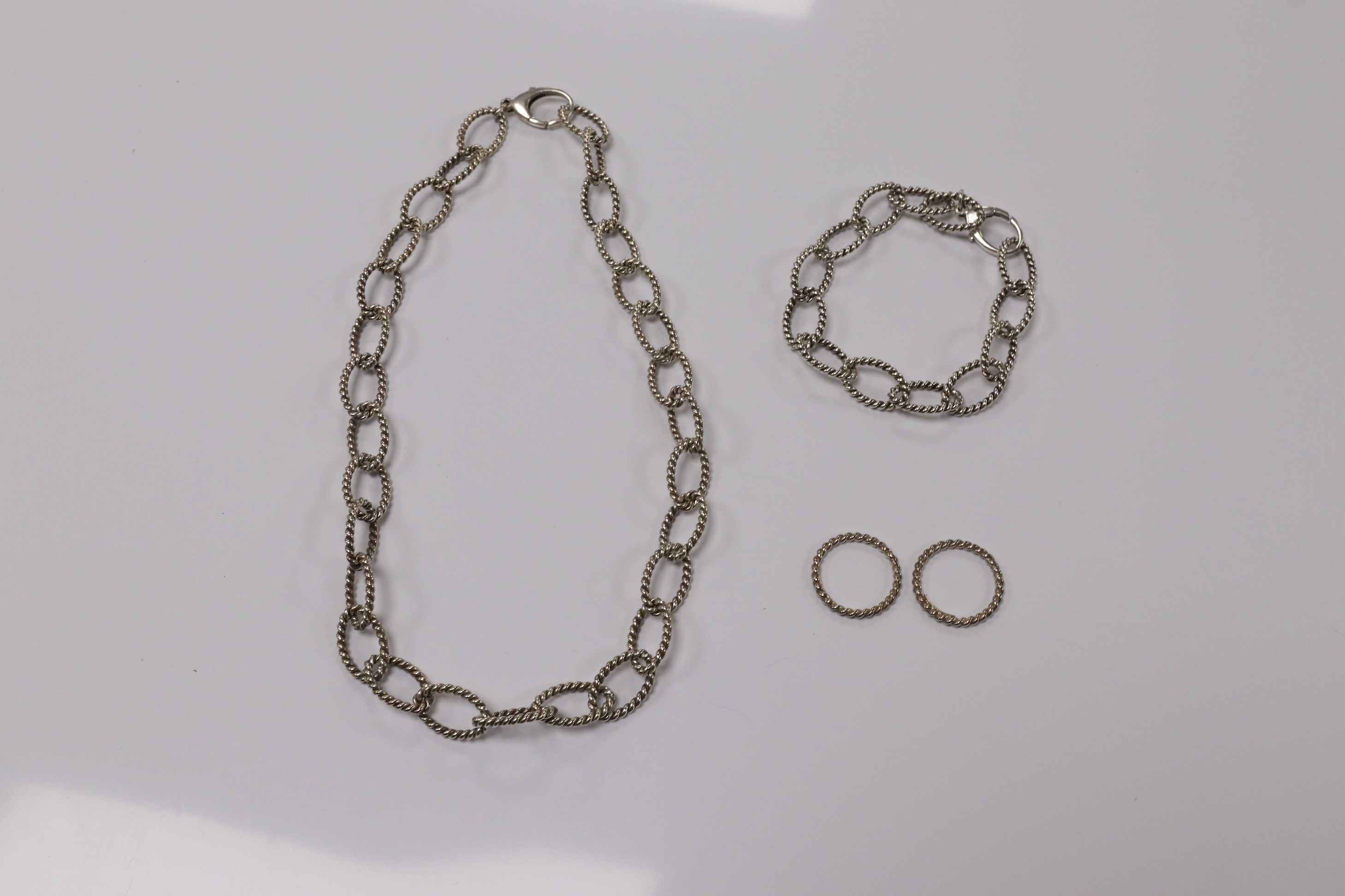 A modern Italian Tiffany & Co 925 suite of jewellery, of rope twist design, comprising a necklace, 42cm, bracelet, 18cm and two rings, size O/P and O. Condition - fair to good